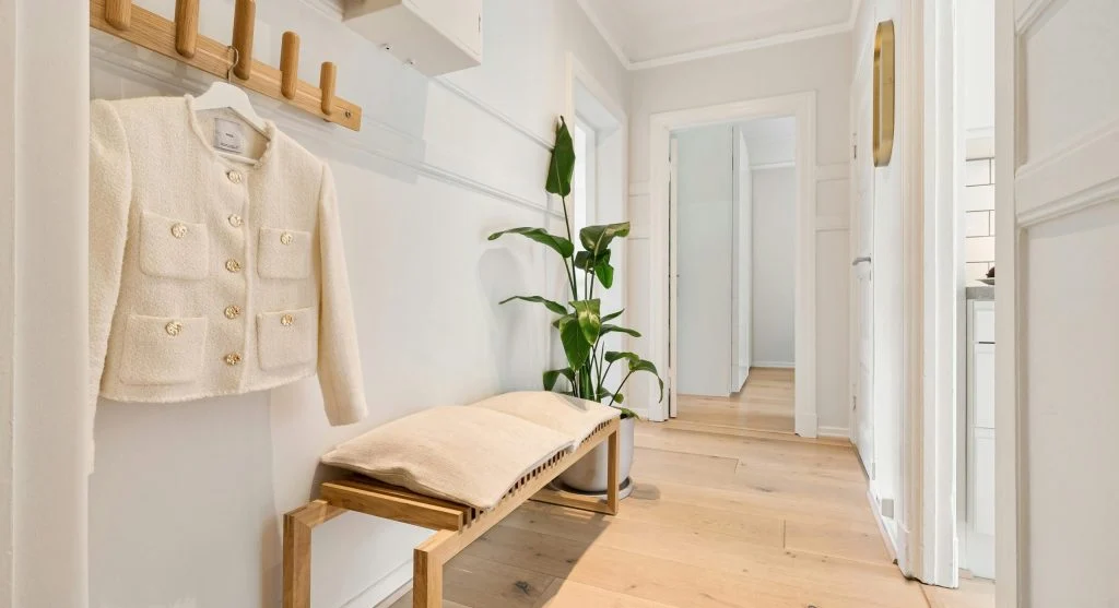 Organized entryway with hooks, basket, and a calendar to support daily habits