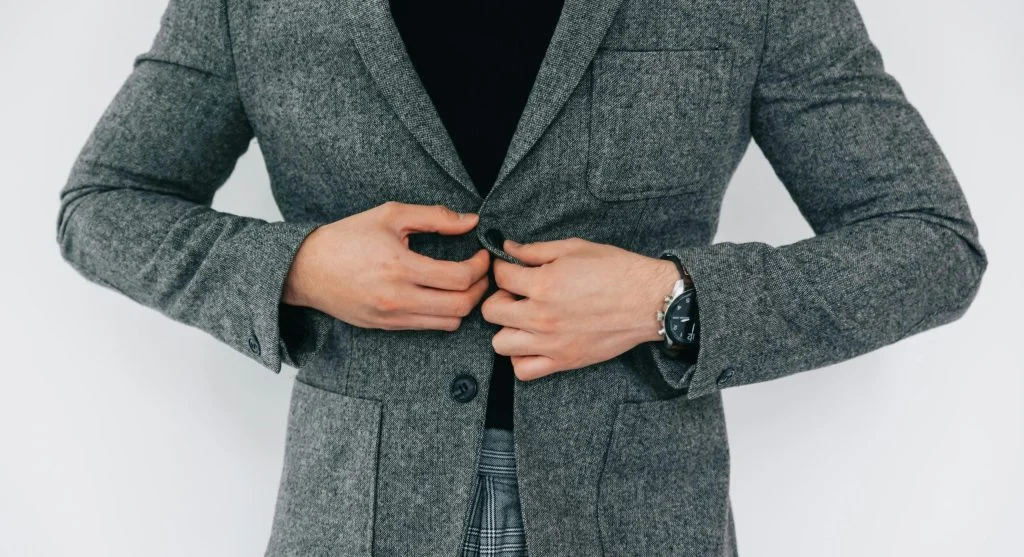 A person wearing ill-fitting jacket and trousers