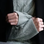 Texture contrast in a simple everyday outfit with soft knitwear and structured pieces