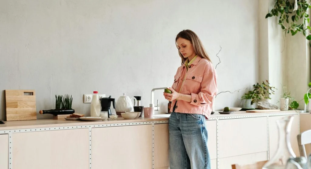 Evening reset focused on a kitchen counter and entryway for an easier morning