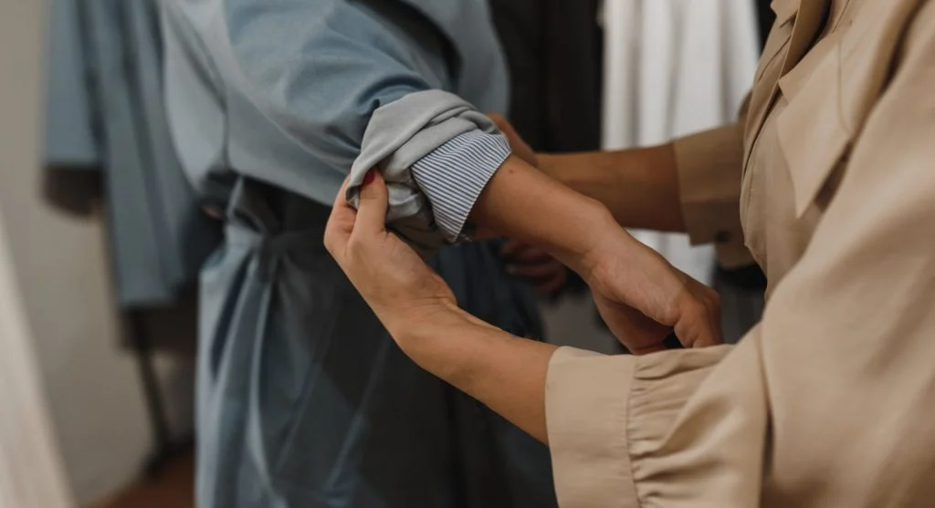Softer shoulder structure created through fabric choice in everyday layers