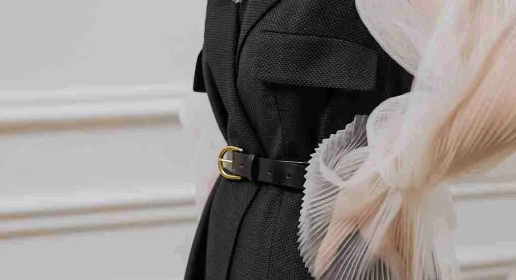 Softer waist emphasis compared with a more sharply cinched and formal outfit shape
